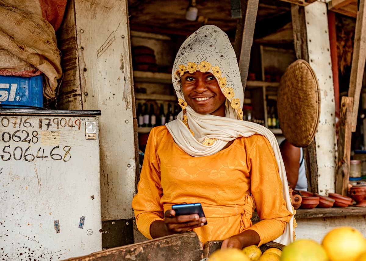 Market merchant with smartphone checking stock