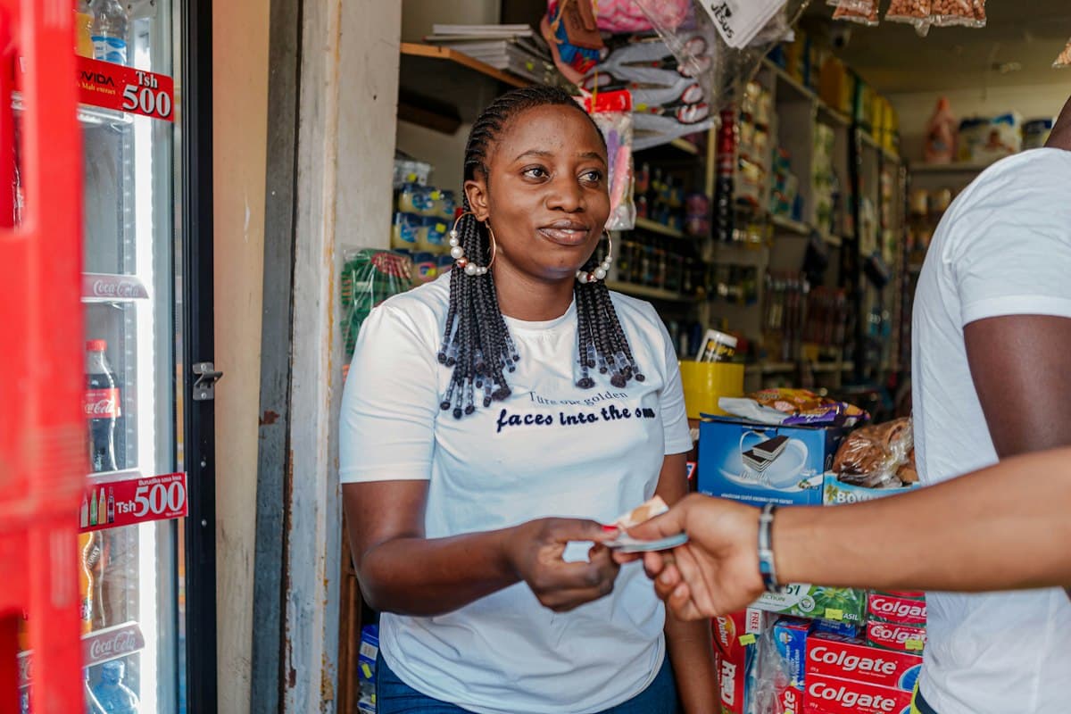 Retail merchant at counter accepting checkout payment